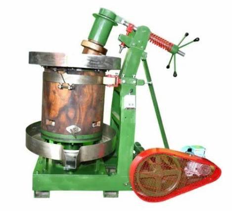 Rotary wooden marachekku machine with a wooden mortar, used to press oil at the Avee Foods unit